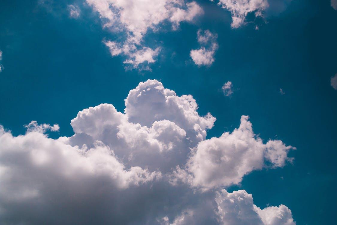 Fluffy white clouds on a blue sky.