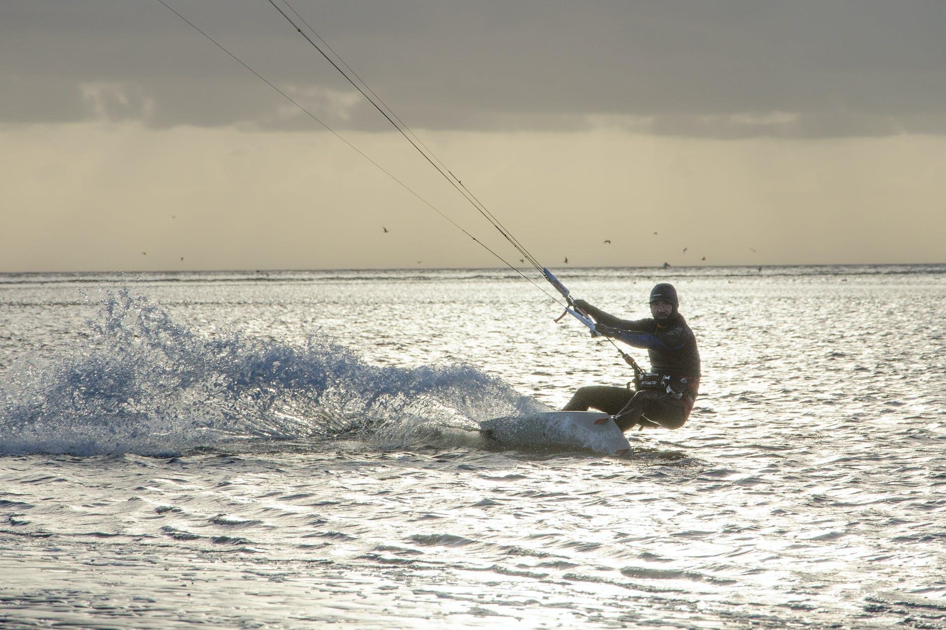 A man enjoying kite surfing