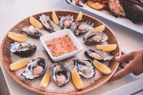 Person serving oyster platter