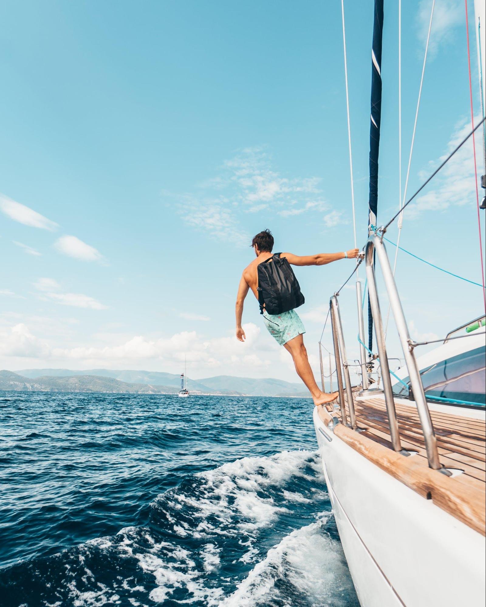 A boy carrying a bag on a luxury yacht in Cabo San Lucas