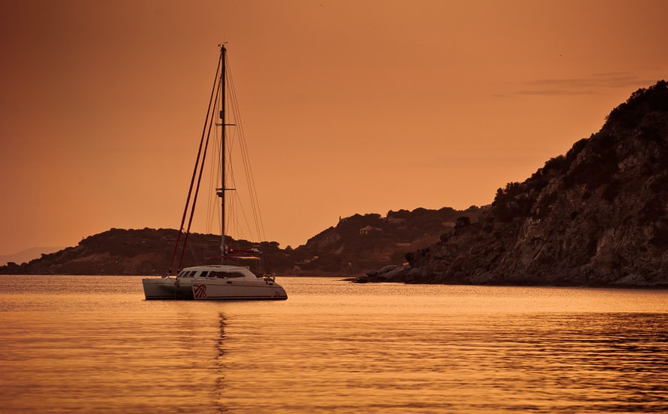 A Yacht Sailing Against An Orange Sky
