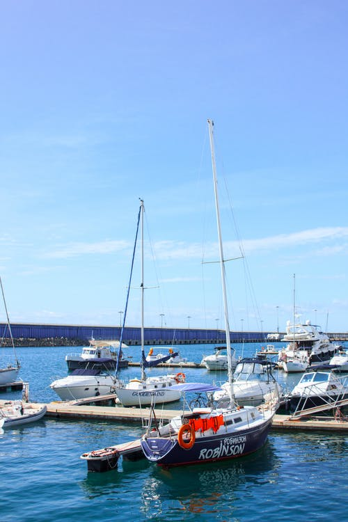 Several yachts docked in the harbor.