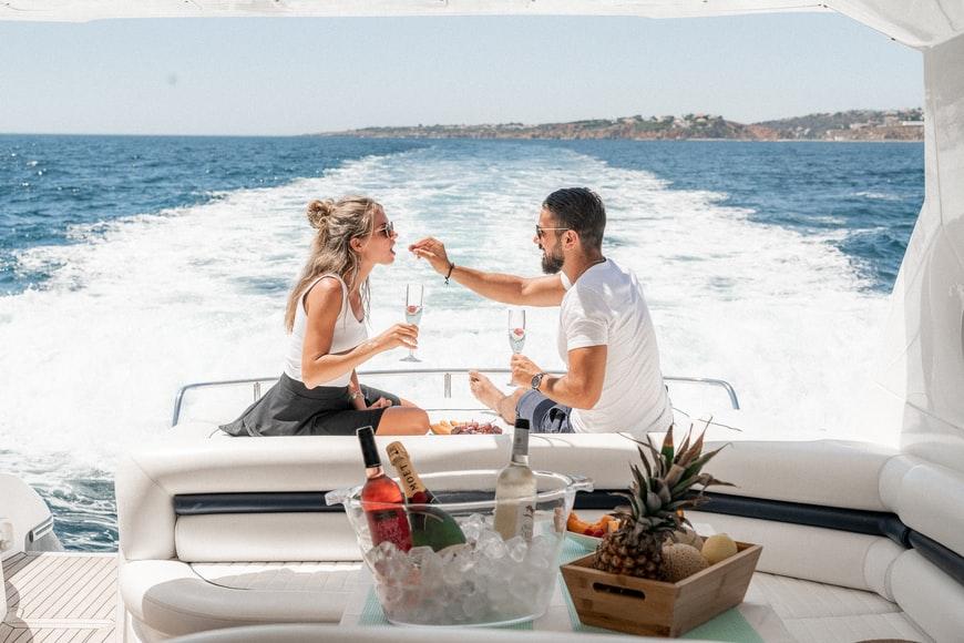 A couple eating on a yacht. 