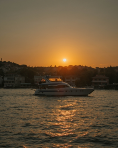 A luxury yacht on the water during sunset